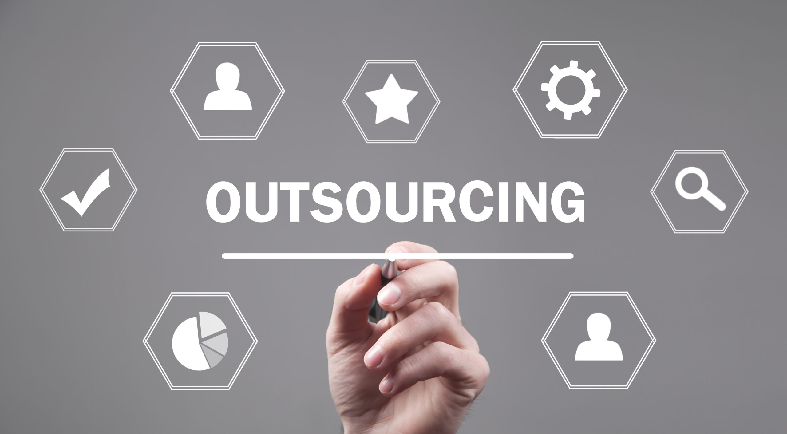 male hand writing screen outsourcing scaled